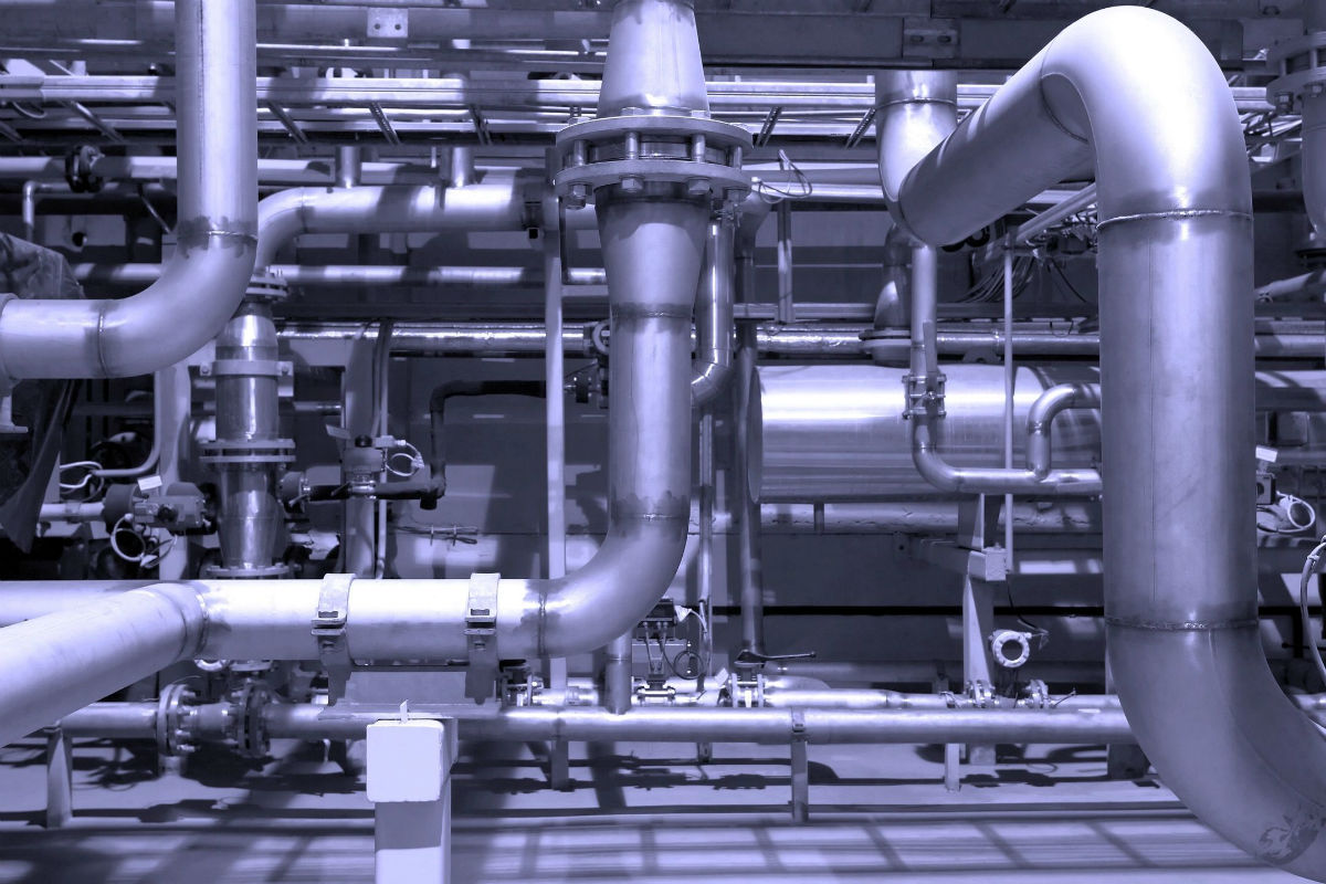Industrial pipes and valves in complex arrangement.